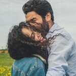 Мужчина целует молодую девушку